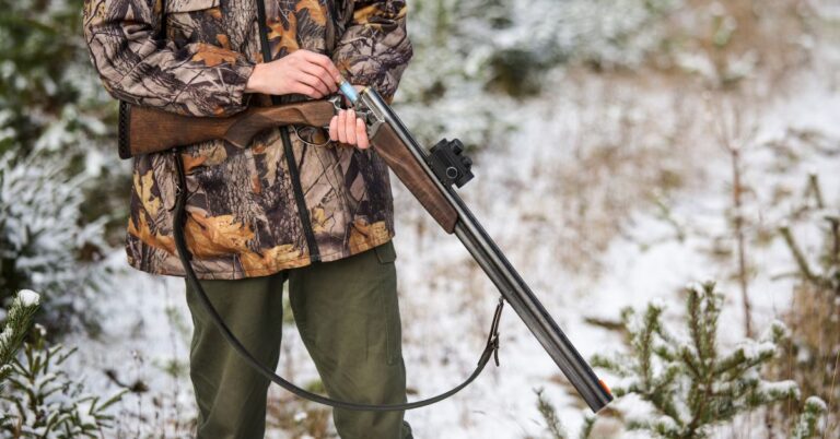 A clean, oiled rifle gun being loaded in the field by a young man. Firearm Maintenance is critical to hunting success
