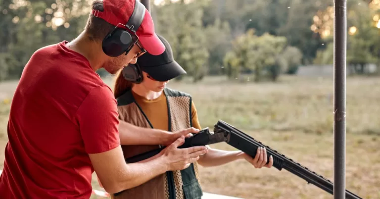 Field instructor helps field day student check weapon