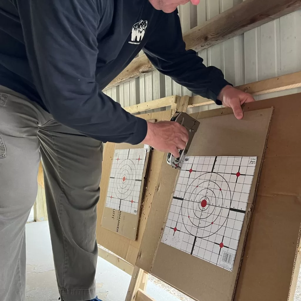 Paper targets for practice are stapled to backer boards
