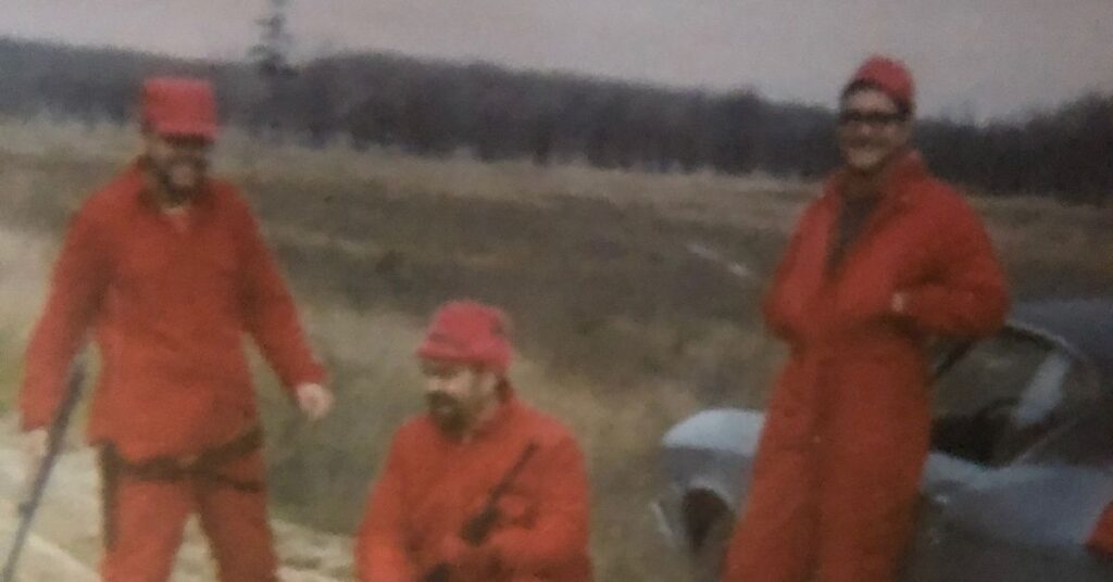 A father and two sons wearing hunters orange