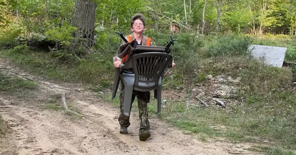 Young hunter carrying hunting chairs to a public land hunting spot. 