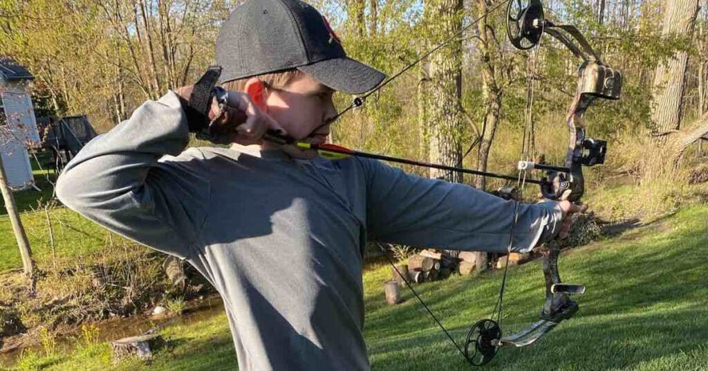 Young hunter practices archery at home