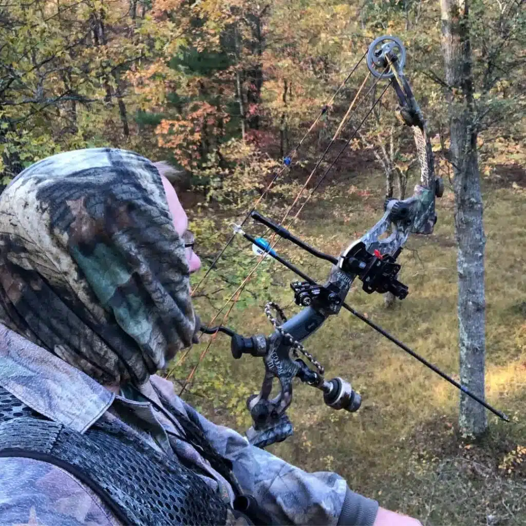 Bow hunter wearing scent lok suit in a treestand