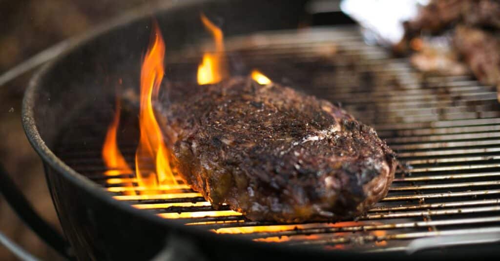 Venison steak on small weber grill.