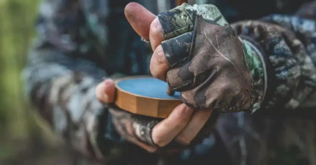 Hands holding a slate turkey call for a turkey bow hunting tip