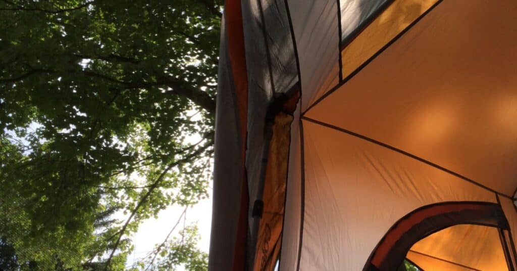 Closeup of a tent feature with trees in the background