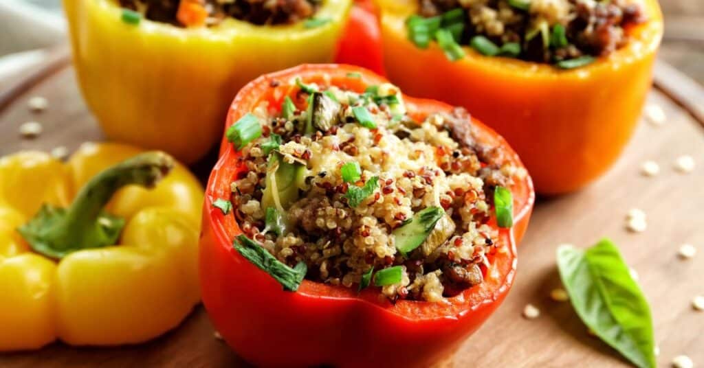 Red and yellow peppers cut open and stuffed with ground turkey and quinoa for a simple 5 ingredient recipe