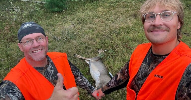 Scott and his son Ethan take a selfie while dragging a doe out of the Michigan woods.